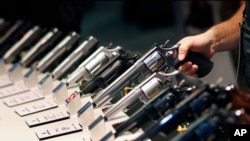 FILE - In this Jan. 19, 2016 file photo, handguns are displayed at the Smith & Wesson booth at the Shooting, Hunting and Outdoor Trade Show in Las Vegas. (AP Photo/John Locher, File)