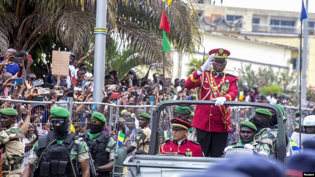 FILE - Gabon coup leader General Brice Oligui Nguema waves after being sworn in as interim president during his swearing-in ceremony, in Libreville, Gabon, Sept. 4, 2023. The U.S. said Sept. 26 it would halt assistance to the country after the military seized power.