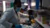 Laboratory technicians test a blood sample for HIV infection at the Reproductive Health and HIV Institute (RHI) in Johannesburg, Nov. 26 2020.