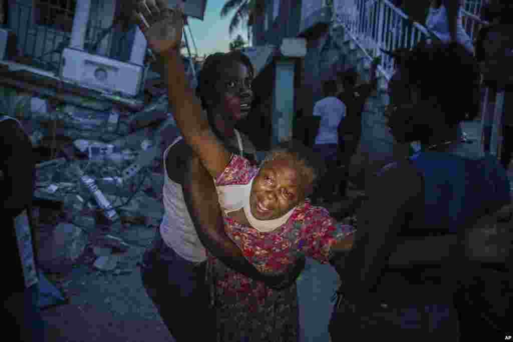 Oxiliene Morency grieves after the body of her 7-year-old-daughter Esther Daniel was recovered from the rubble of their home destroyed by the earthquake in Les Cayes, Haiti, Aug. 14, 2021.