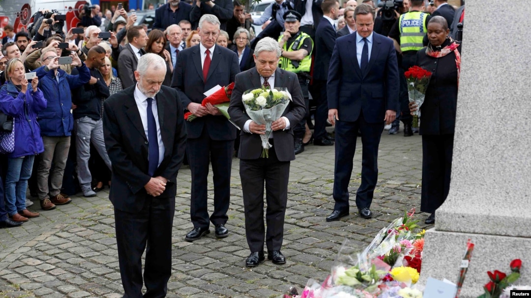 Britain's Prime Minister David Cameron, second from right, stands with Labour Party leader Jeremy Corbyn, left, John Bercow, Speaker of the House of Commons, center, and Labour MP Hilary Benn, second left, as they pay tribute near the scene where Labour Member of Parliament Jo Cox was killed in Birstall, near Leeds, June 17, 2016.