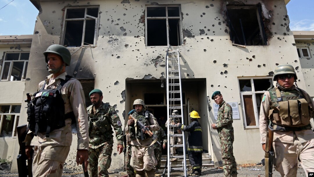 Afghan security personal surround the area after Taliban fighters stormed a government building in Jalalabad, east of Kabul, May 12, 2014. 