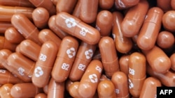 This handout photo obtained May 26, 2021 courtesy of Merck & Co,Inc. shows the experimental antiviral drug Molnupiravir. The drug is one of several under testing for COVID-19. (Handout / Merck/ AFP)