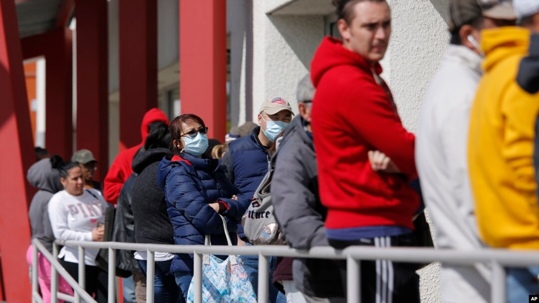 FILE - People wait in line for help with unemployment benefits in Las Vegas, Nevada, March 17, 2020.