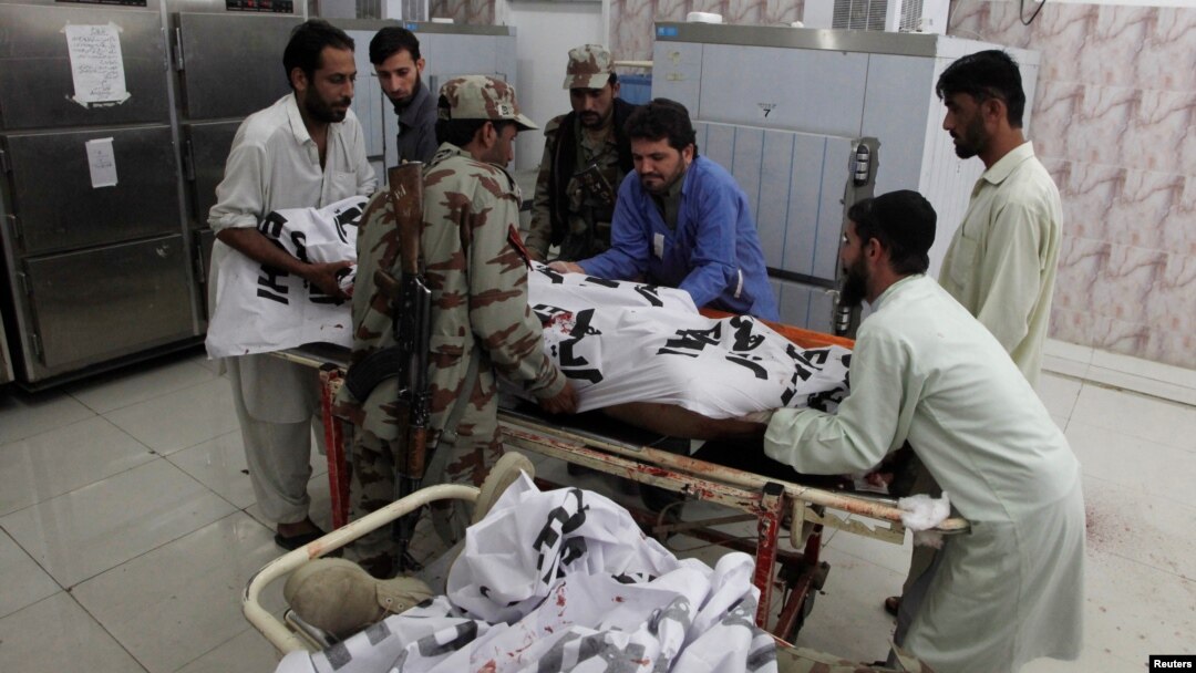 Soldiers help paramedics move the body of one of four Frontier Corps personnel killed by gunmen in Quetta, Pakistan, June 29, 2016.