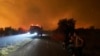 Flames burn a forest during a wildfire in Skepasti village on the island of Evia, about 150 kilometers (93 miles) north of Athens, Greece, Aug. 5, 2021. Wildfires rekindled outside Athens and forced more evacuations around southern Greece.
