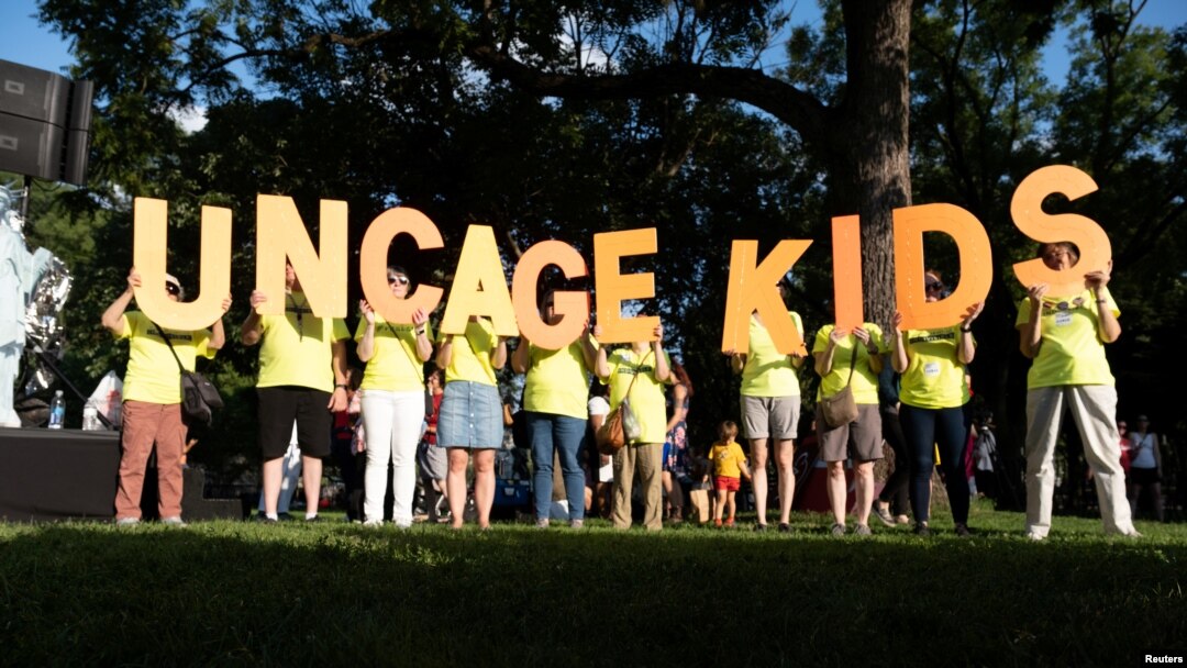 Immigration rights activists hold a "Lights for Liberty" rally and candle light vigil in front of the White House in Washington, July 12, 2019. 