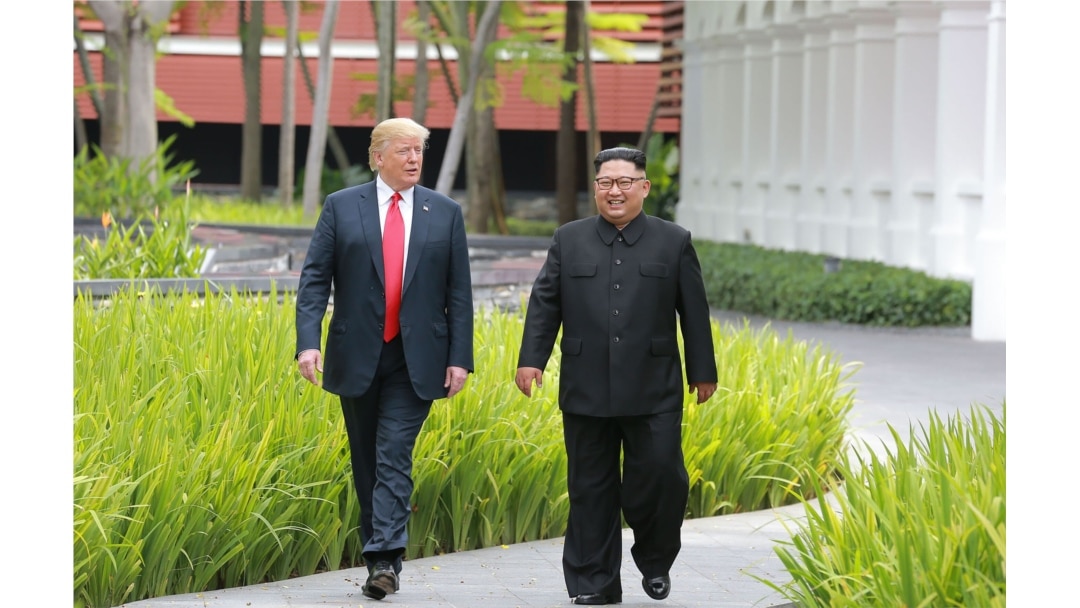 FILE - North Korea's leader Kim Jong Un, right, walks with U.S. President Donald Trump at the Capella Hotel on Sentosa island in Singapore, in this picture taken June 12, 2018, and released from North Korea's Korean Central News Agency.