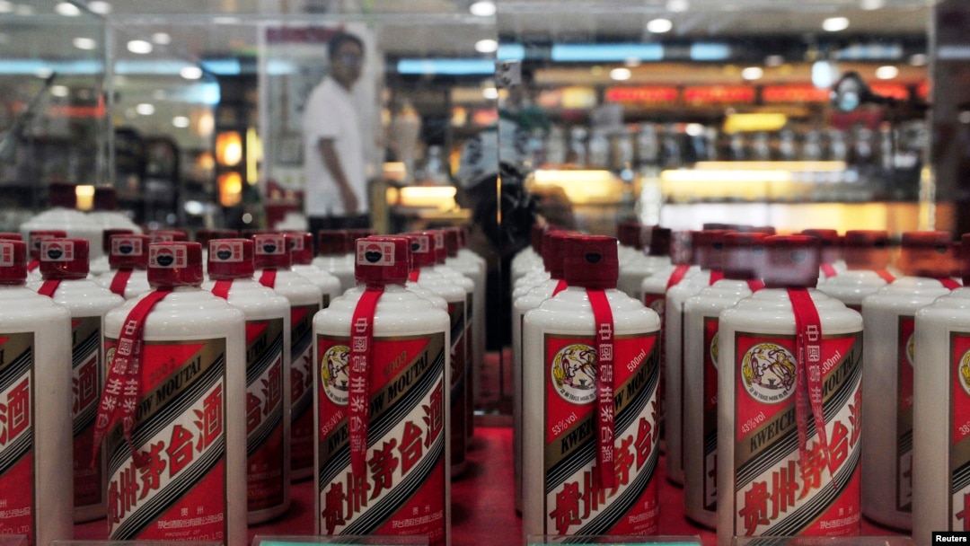 FILE - A customer walks past a glass case displaying Maotai liquors at a supermarket in Shenyang, Liaoning province, Aug. 8, 2012.