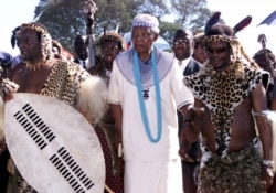 FILE - Former South African president Nelson Mandela, center, and Zulu King Goodwill Zwelithini, left, wear traditional Zulu and Xhosa clothes during the wedding of the king's daughter, Princess Nandi, Dec. 7, 2002.