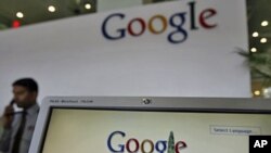 A security personnel answers a call at the reception counter of the Google office in the southern Indian city of Hyderabad , India, February 6, 2012