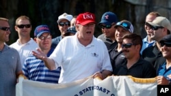 President Donald Trump speaks as he meets with members of the U.S. Coast Guard, who he invited to play golf, at Trump International Golf Club, Friday, Dec. 29, 2017, in West Palm Beach, Florida. 