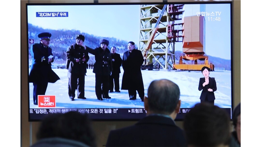 A man watches a TV screen showing a file image of the North Korean leader Kim Jong Un at his county long-range rocket launch site during a news program at the Seoul Railway Station in Seoul, South Korea, Monday, Dec. 9, 2019.