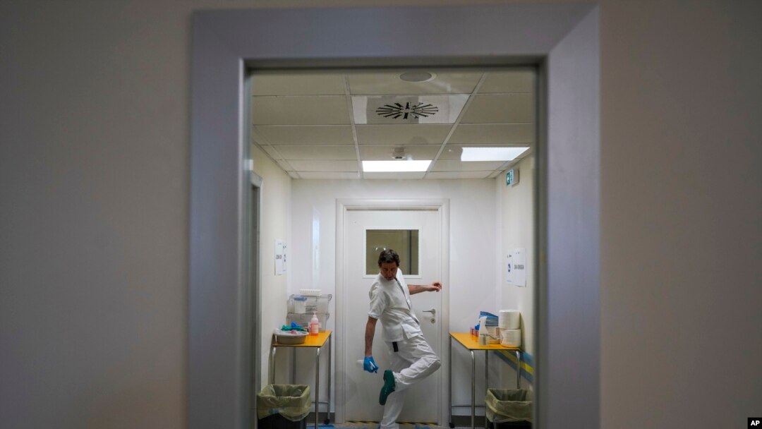 A doctor disinfects his shoes as he leaves the ICU unit of Rome's San Filippo Neri Hospital's Covid department, in Rome, April 9, 2020.