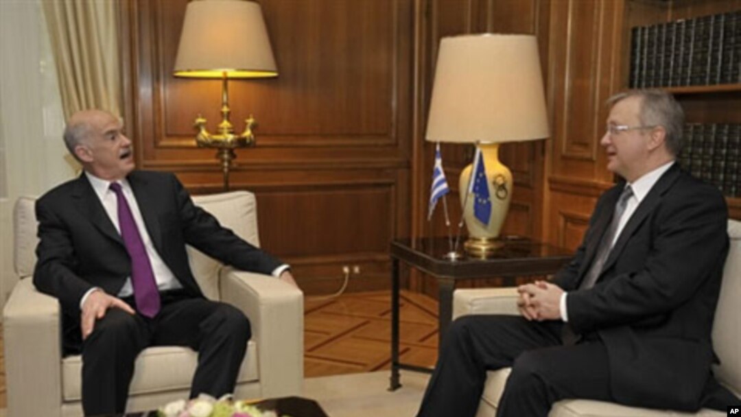 EU economic and monetary affairs commissioner Olli Rehn (R) meets with Greek Prime Minister George Papandreou (L). Greece must do more to reduce its deficit and end a fiscal crisis 01 Mar 2010