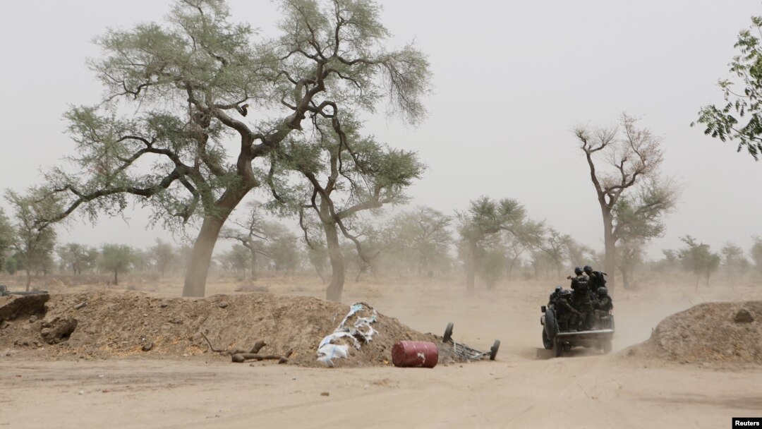 FILE - Cameroonian soldiers from the Rapid Intervention Brigade ride in a military pickup truck at their base in Achigachia, Cameroon, March 16, 2016.