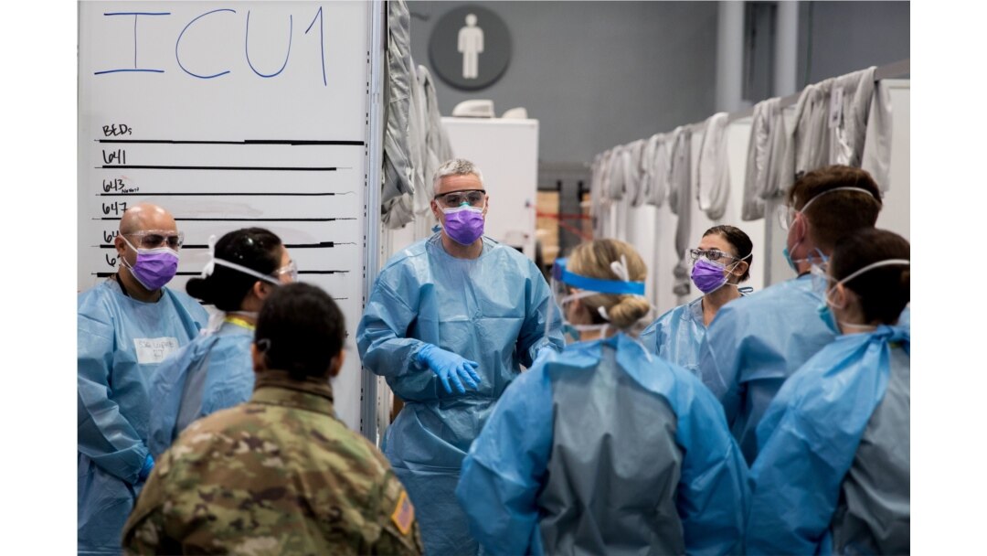FILE - U.S. Army Major Sean Shirley holds a meeting with staff in the Javits New York Medical Station intensive care unit bay monitoring coronavirus disease (COVID-19) patients in New York City, April 4, 2020.