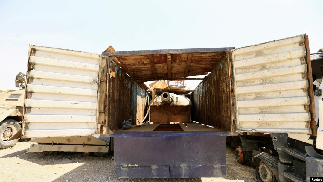 A tank gun hidden inside a truck, made by Islamic State militants, to avoid attack from planes are seen at Federal Police Headquarters after being confiscated in Mosul, Iraq July 13, 2017.