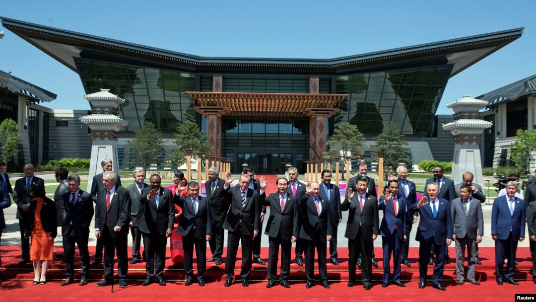 Leaders attending the Belt and Road Forum wave as they pose for a group photo at the Yanqi Lake venue on the outskirt of Beijing, China, May 15, 2017. 