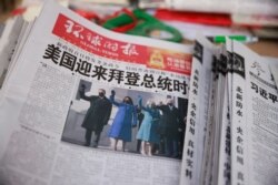 FILE - A copy of the Global Times newspaper featuring an image of U.S. President Joe Biden and Vice President Kamala Harris on its front page is seen at a newsstand in Beijing, China, Jan. 21, 2021.