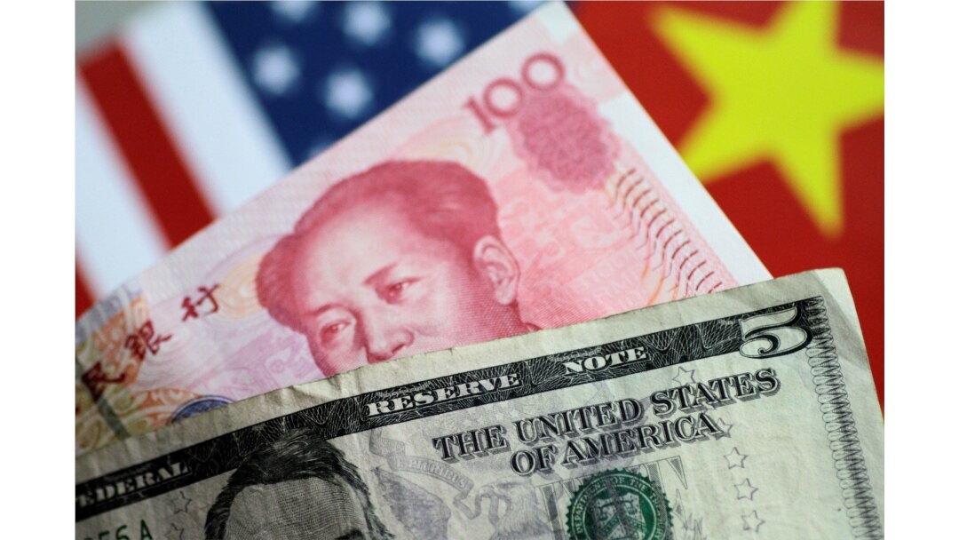FILE - U.S. Dollar and China Yuan notes are seen in this picture illustration, June 2, 2017.