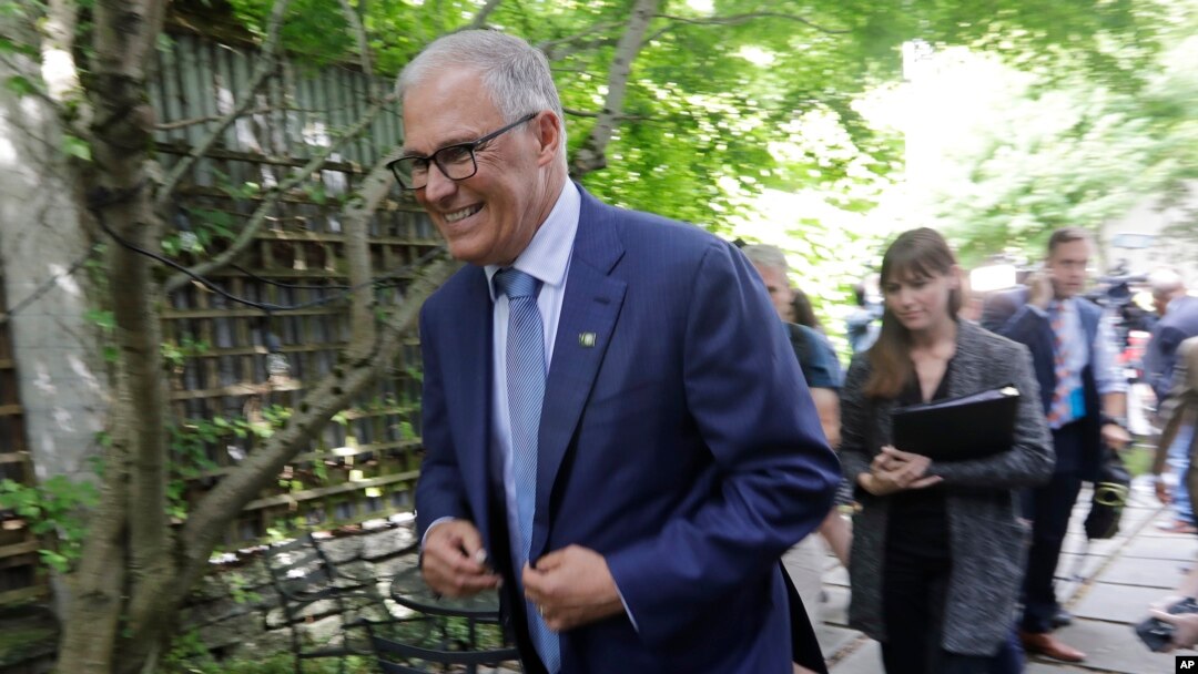Washington Gov. Jay Inslee heads out after speaking with reporters about his plans to run for a third term, Aug. 22, 2019, in Seattle. Inslee ended his climate change-focused 2020 presidential bid a day earlier. 