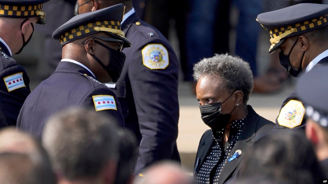 FILE - Chicago mayor Lori Lightfoot, right, and Police Superintendent David Brown, center left, assemble outside a funeral service for a police officer killed in the line of duty, Aug. 19, 2021, in Chicago.