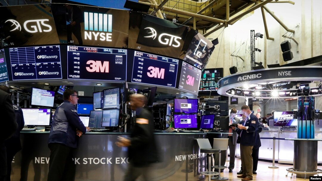 FILE PHOTO: Traders work on the floor at the New York Stock Exchange in New York, Aug. 6, 2019. 