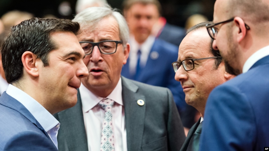 Greek Prime Minister Alexis Tsipras, left, speaks with, from left, European Commission President Jean-Claude Juncker, French President Francois Hollande and Belgian Prime Minister Charles Michel during a meeting of eurozone heads of state at the EU Council building in Brussels on Sunday, July 12, 2015. (AP Photo/Geert Vanden Wijngaert)