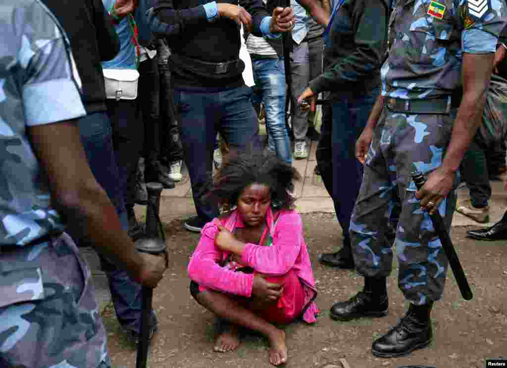 Ethiopian Federal Police officers detain a woman suspected of carrying explosives during the welcoming ceremony of Jawar Mohammed, U.S.-based Oromo activist and leader of the Oromo Protests, in Addis Ababa, Ethiopia.
