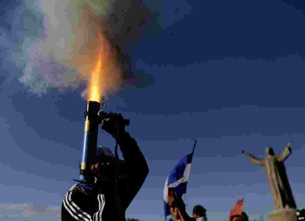 An anti-government protester fires a home-made mortar during a march dubbed "Here nothing is normal", in Managua, Nicaragua, Aug. 18, 2018.