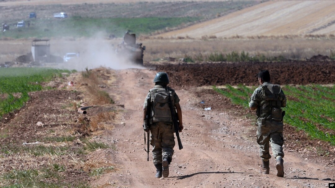 FILE - Turkish soldiers patrol near the border with Syria, east of Kilis, Turkey, July 24, 2015. Iraq has demanded Turkey remove troops from within its borders.
