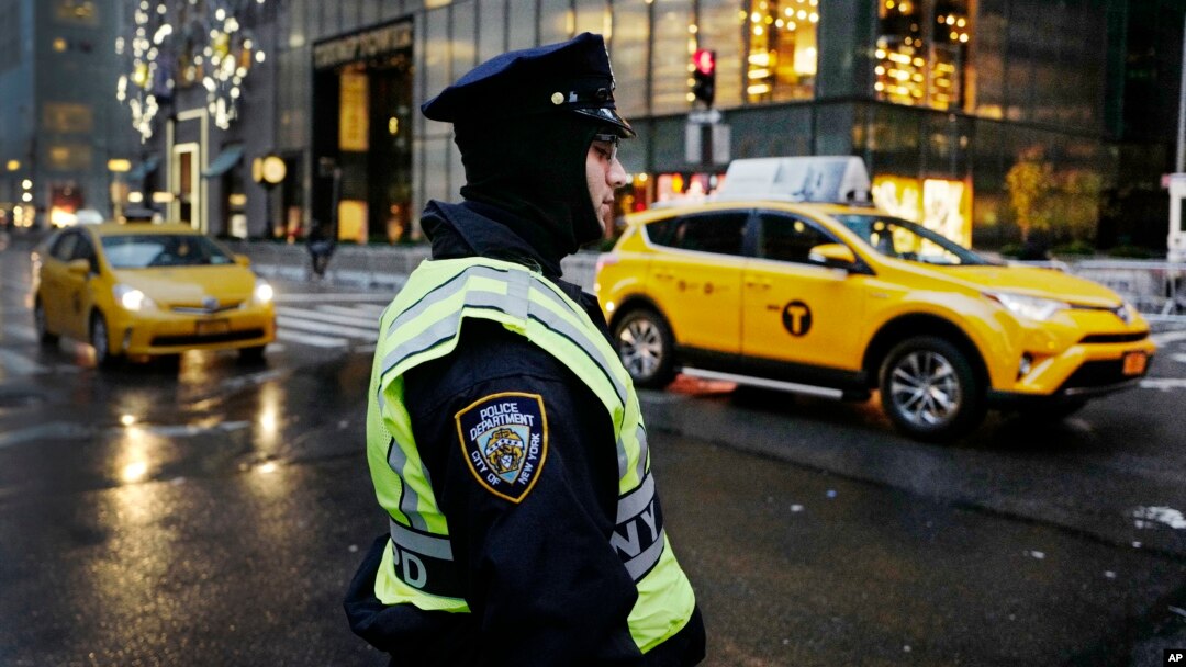 A New York City police officer stands watch outside Trump Tower, Dec. 5, 2016, in New York. 
