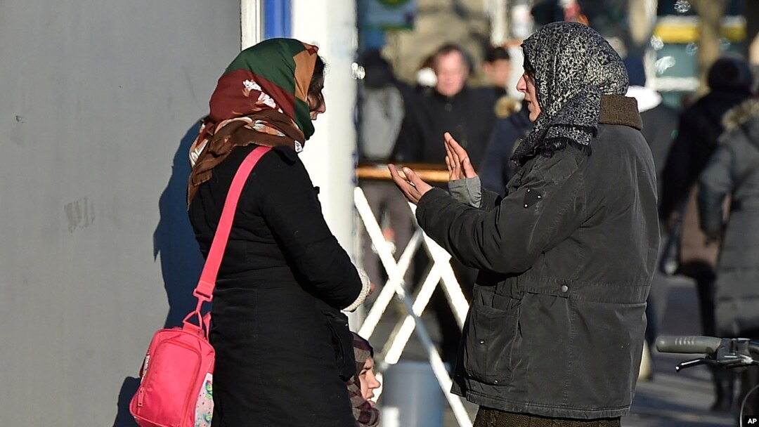Two women talk in the so called "Mahgreb Quarter" in Duesseldorf, Germany, Jan. 19, 2016. Germany is still taking in around 2,000 refugees a day, but it is now denying entry to about 200 others daily at its borders, the country’s interior minister said on Jan. 24, 2016.